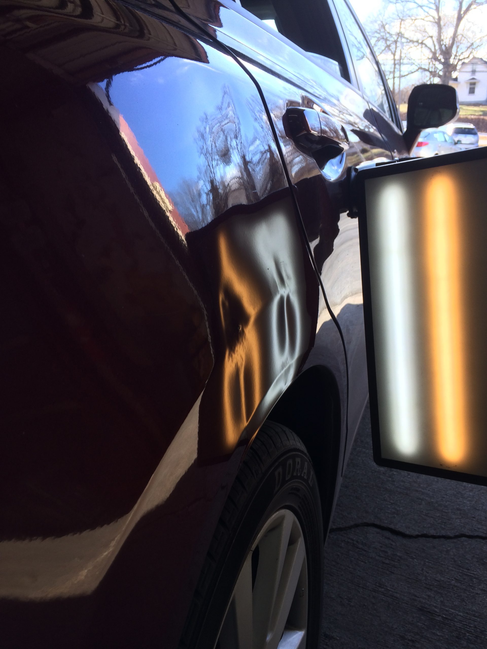 Large dent before paintless dent repair evaluation