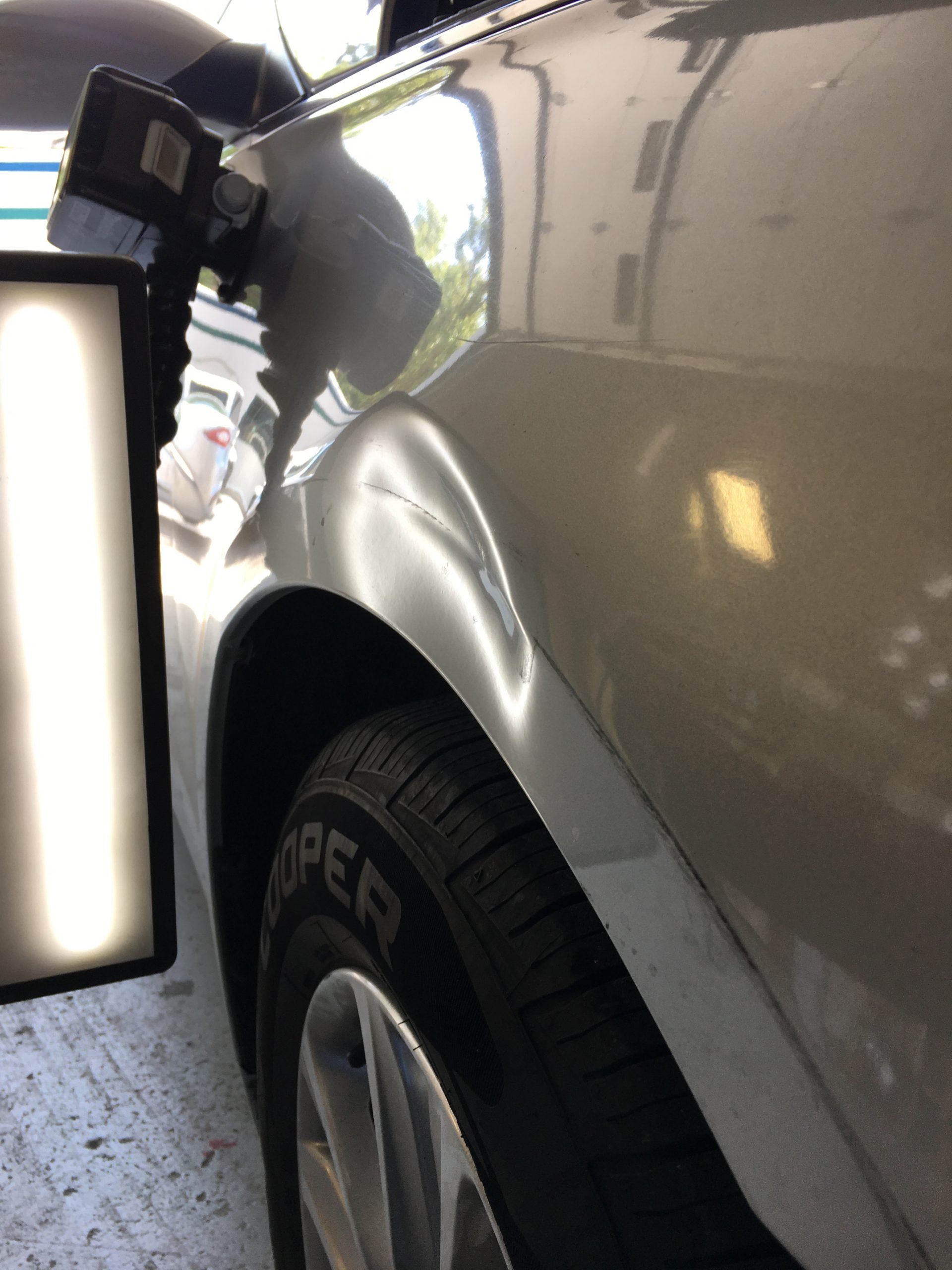 Vehicle panel with dent damage before repair